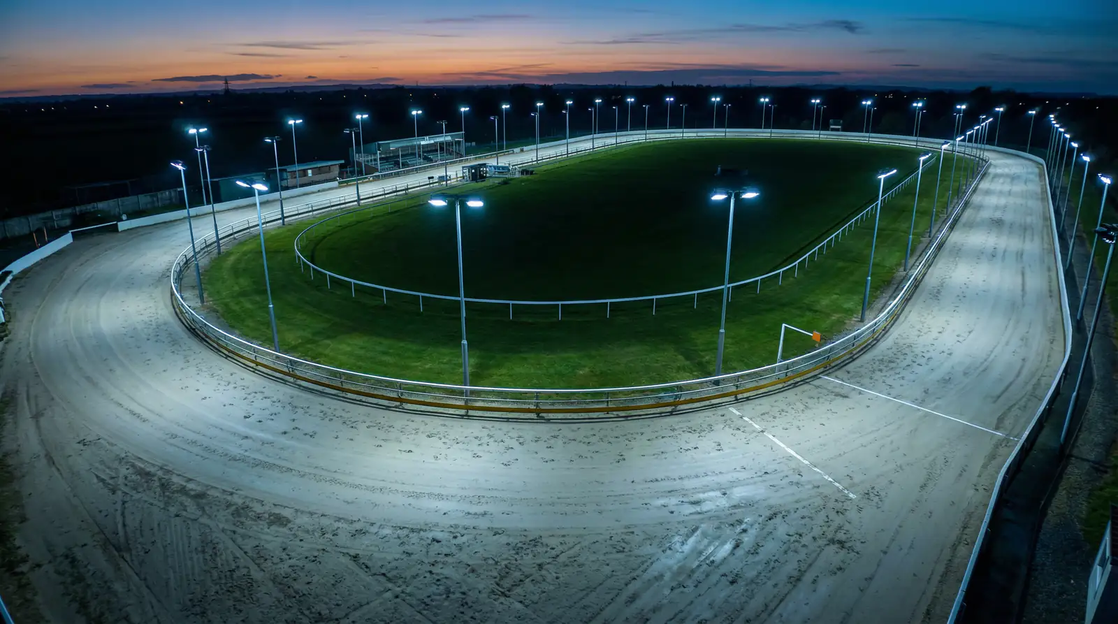 Greyhound racing distances — wide view of a UK greyhound track showing the full circuit